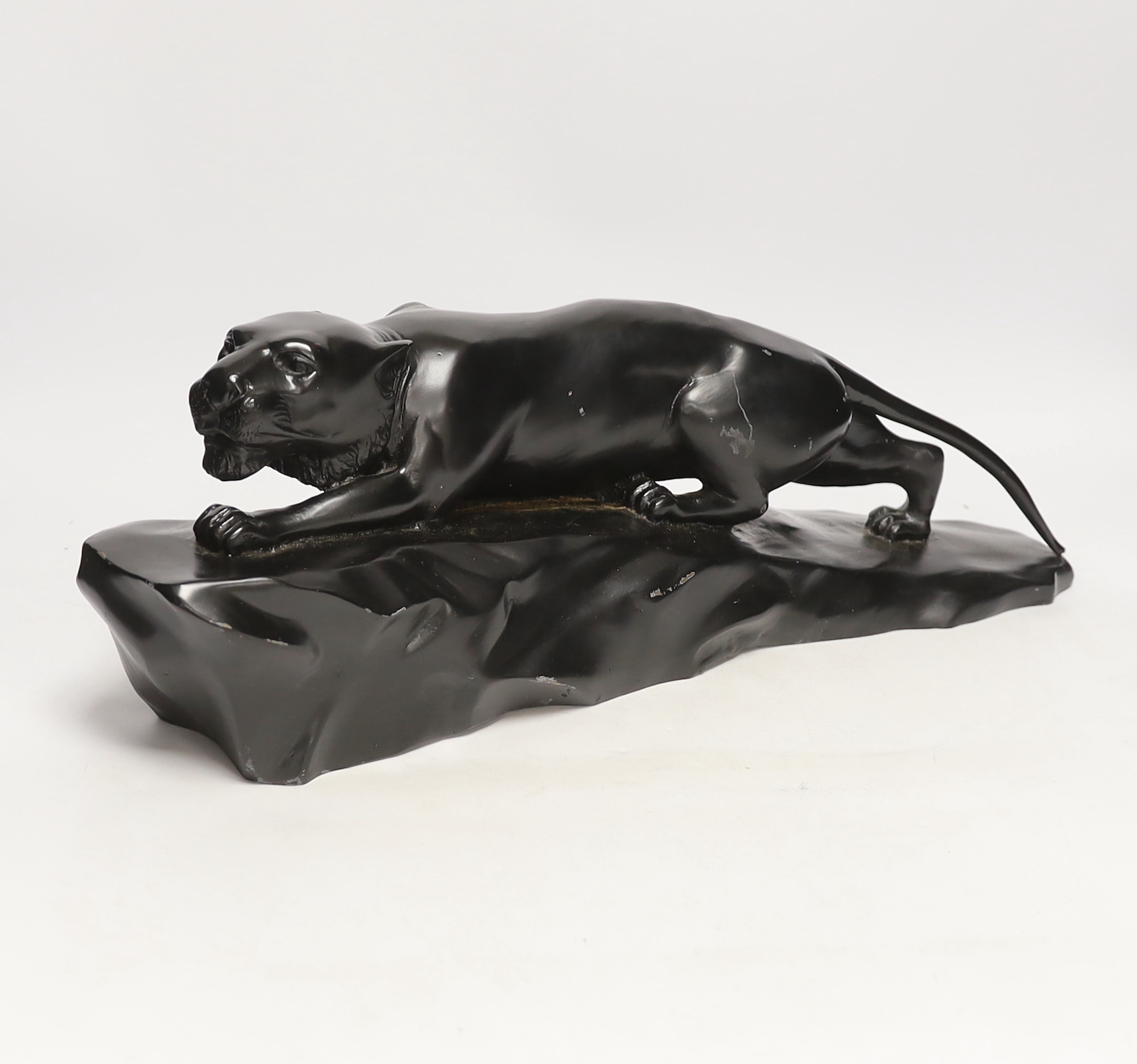 A bronzed black painted spelter panther, 50cm wide